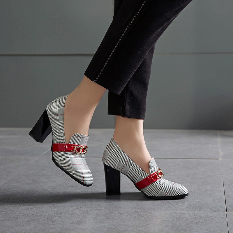 Side profile of plaid block heel pumps with chain detail